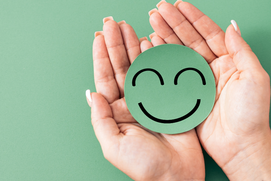 Two hands holding a smiley face